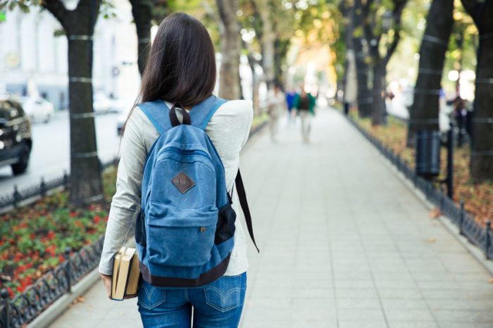 Back View Portrait Of A Female Student Walking