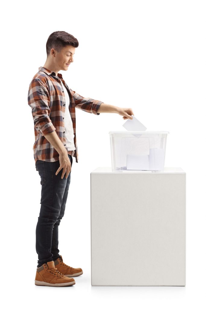 Full Length Profile Shot Of A Young Guy Voting On Elections