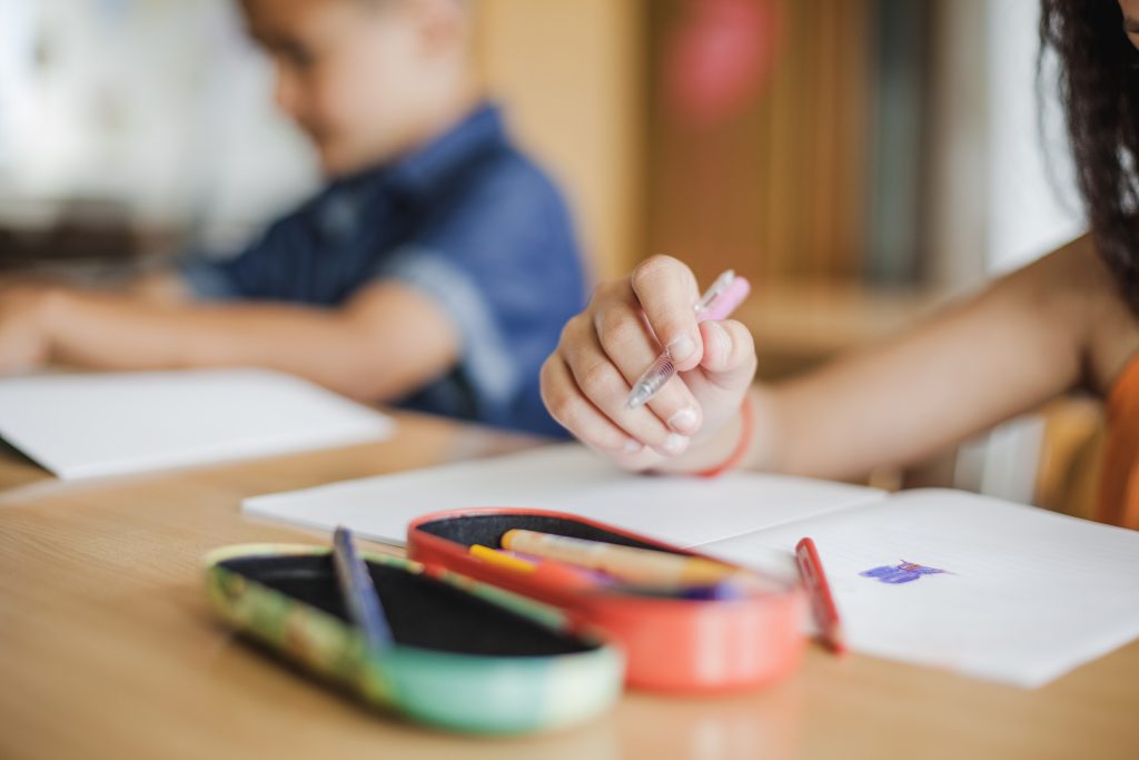 Schoolchildren Sitting Desk With Notebooks (1)