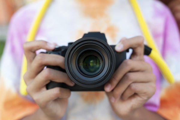 Close Up Hands Holding Camera